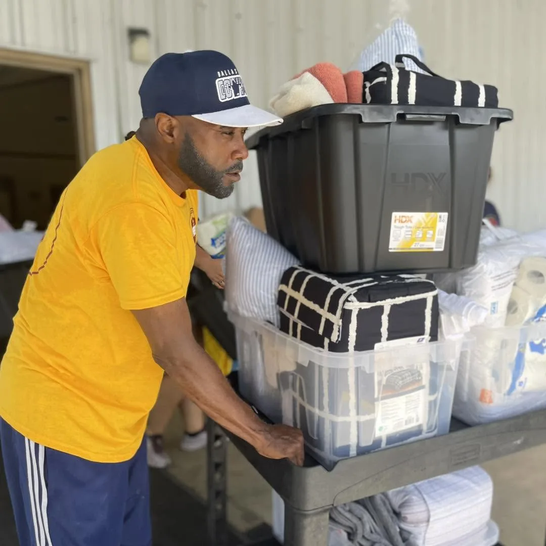 Volunteer organizing storage bins of supplies