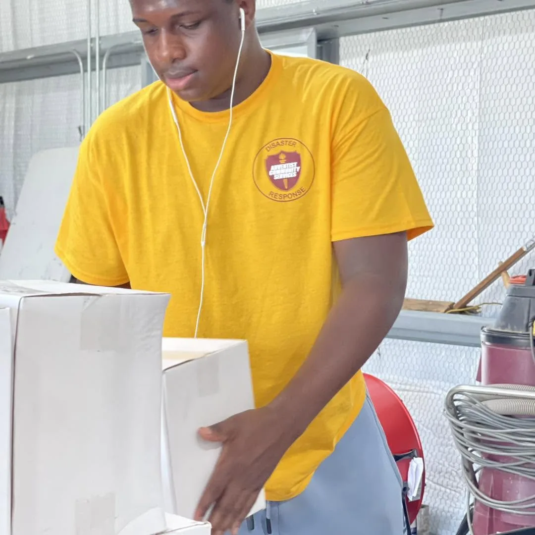 Youth volunteer moving boxes
